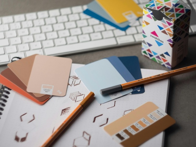 Colour swatches, sketches and pencils arranged for brand direction planning
